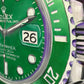 Close-up of a green Rolex watch face with purple accents