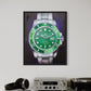 Framed picture of a green watch on a shelf with electronic equipment and books.