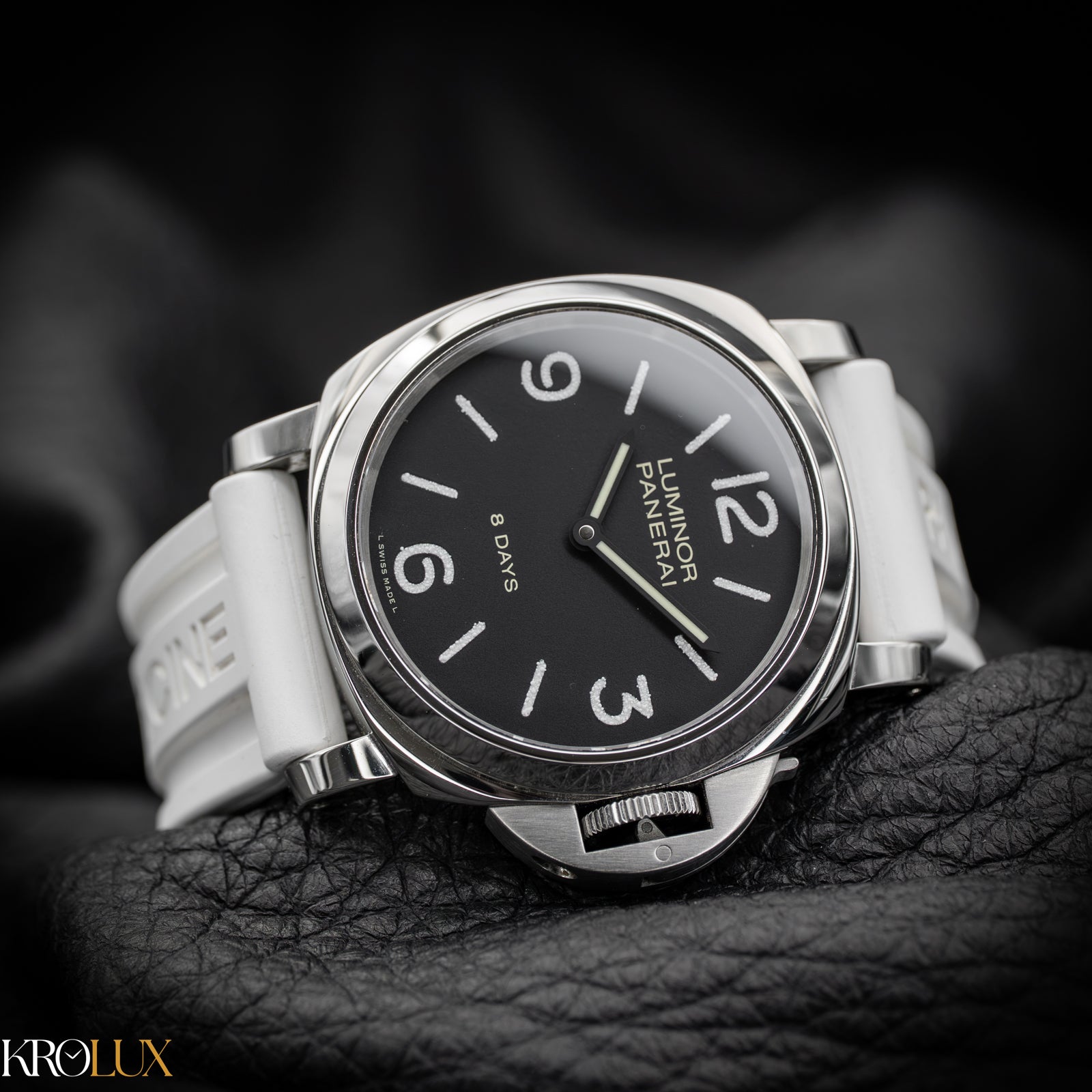 Panerai watch with black dial and white strap on a dark background
