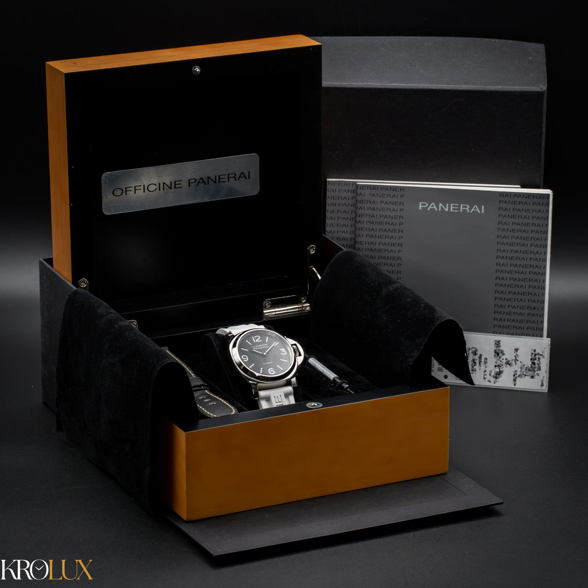 Panerai watch in an open box with accessories on a dark background