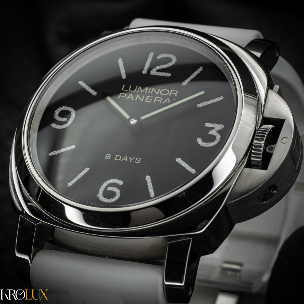 Luminor Panerai watch with black dial and silver case on a dark background