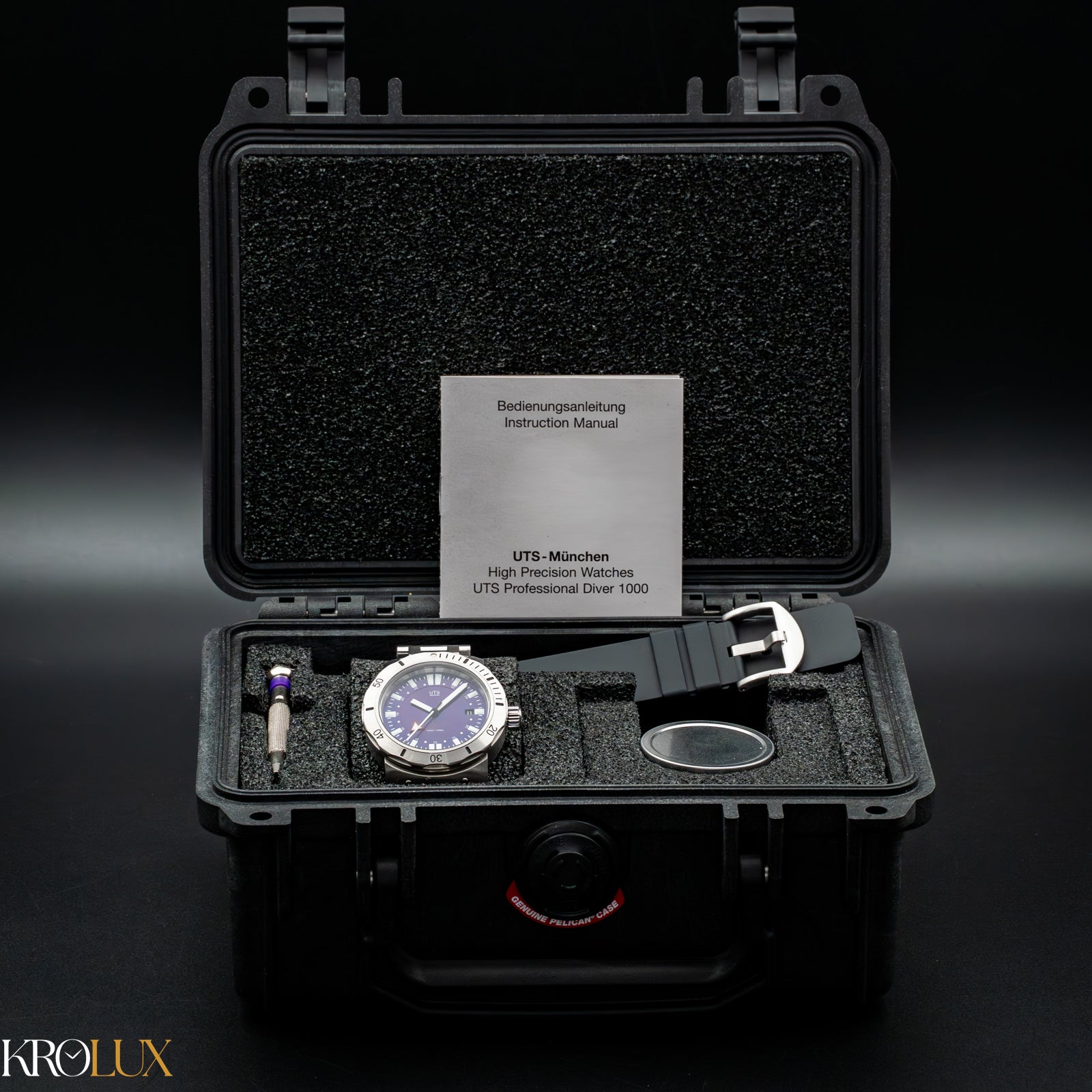 Box shot. Watch in a black case with an instruction manual on a dark background, featuring the Krolux brand.