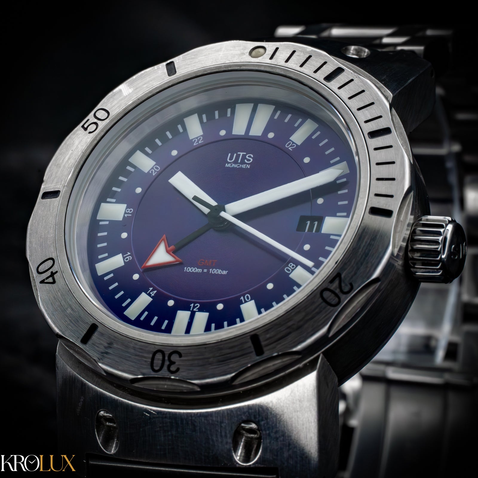 Close up. Wristwatch with a blue dial and silver case on a dark background